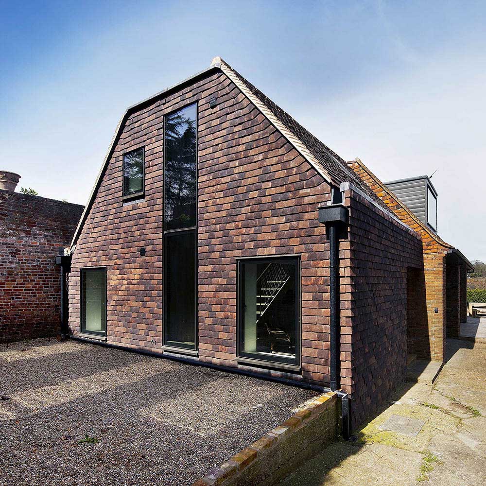 Contemporary single-storey brick house extension with architectural glazing in Loughton