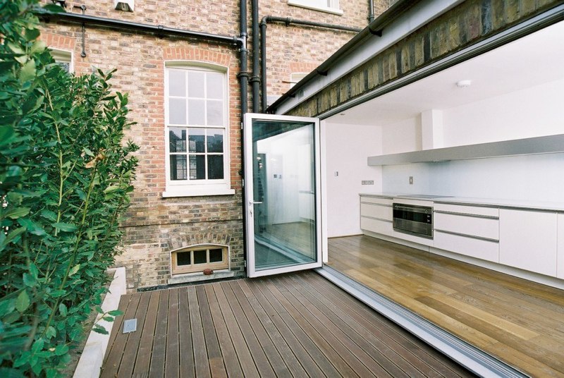 Open-plan extension featuring bi-fold glass doors and modern kitchen in Essex
