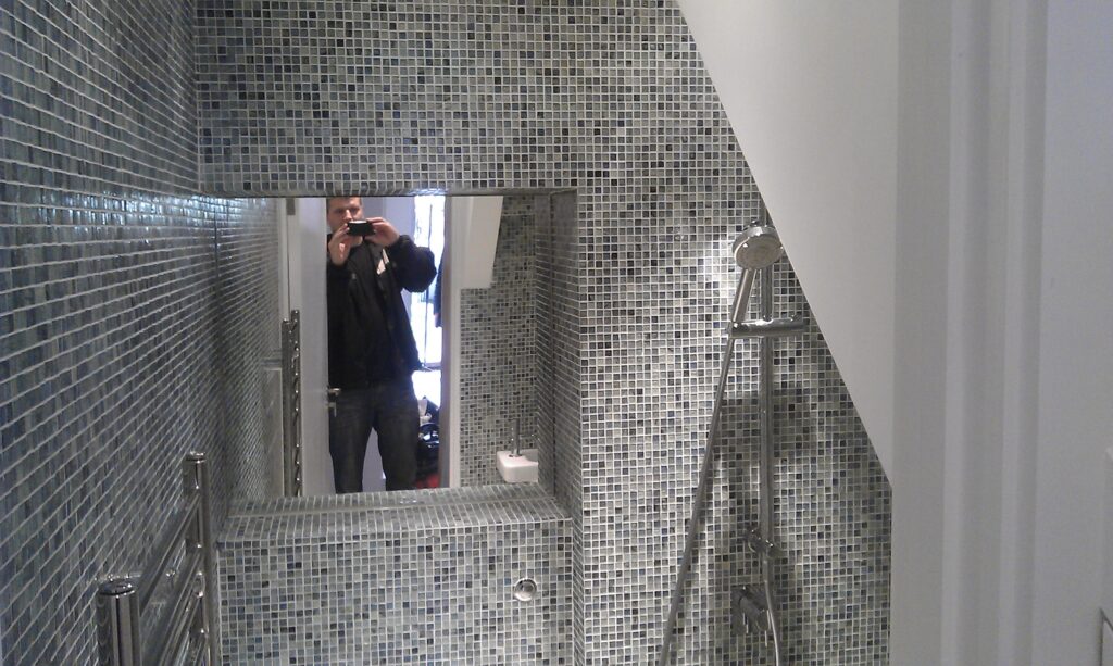Bespoke tiled shower niche and bathroom installation detail